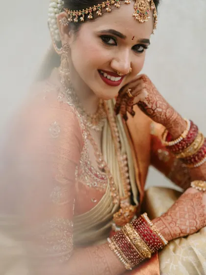 A soft, dreamy portrait of the bride. The lighting catches the subtle glow on her skin, a result of careful skin prep and the dewy finish I love to create.