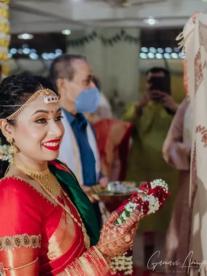 A candid moment during the wedding rituals. The makeup is designed to be sweat-proof and long-lasting, ensuring the bride looks fresh and radiant all day.