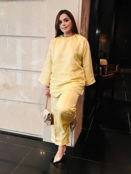 A full-length look at this elegant yellow co-ord set. Paired with a simple bag and heels, it's a complete look that is both comfortable and chic.