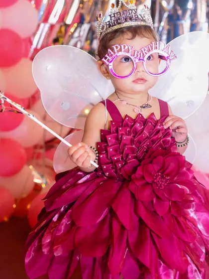 A magical portrait of the birthday girl dressed as a fairy, complete with wings, a wand, and fun glasses.