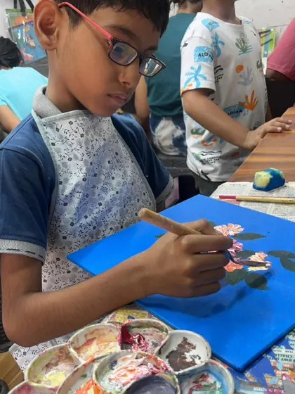 Using a palette knife, this young artist is learning to create textured flowers. Our kids' canvas courses often introduce different tools to make painting more exciting.