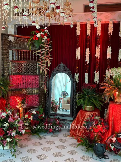 Details matter in creating an immersive experience. This photo booth for a traditional wedding features an antique-style mirror, a carved wooden shelf, and rich red fabrics, offering guests a perfectly themed spot for photos.