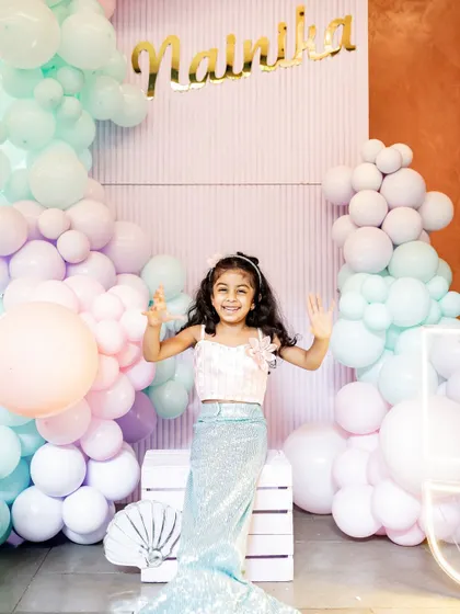 A magical mermaid-themed birthday party for little N. She looks so happy in her sparkly mermaid tail, ready to celebrate with her friends and family. I love working with you to bring fun party themes to life.