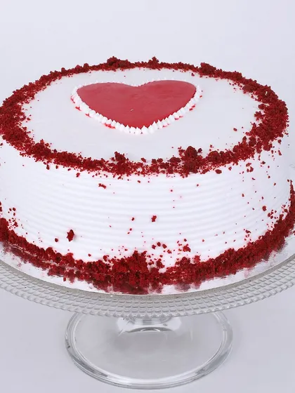 Our classic red velvet cake gets a romantic touch with a simple heart design on top. The iconic red sponge and cream cheese frosting are sprinkled with red velvet crumbs for a beautiful finish.