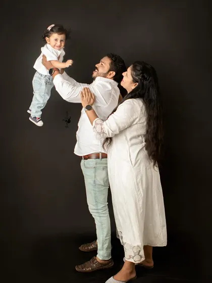 A beautiful family moment filled with pure happiness. The simple joy of a father lifting his child into the air is a memory I feel honored to capture against a classic studio backdrop.
