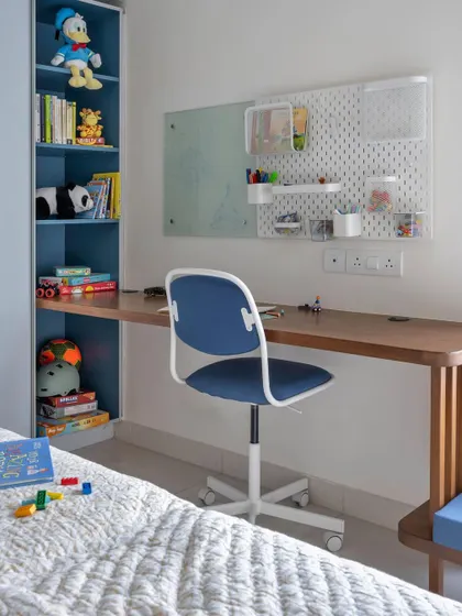 The study area in the 'Utopian Dreams' kids' room, with a built-in bookshelf and a pegboard for flexible organization.