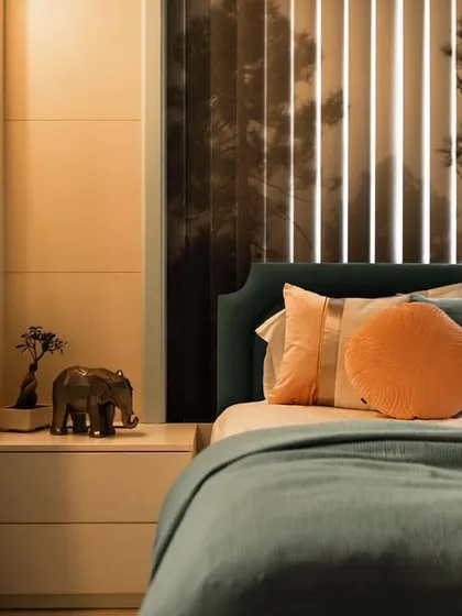 A closer look at the kids' bedroom, focusing on the bedside details. A small bonsai tree and a decorative elephant sit on the nightstand, adding a touch of whimsy. The custom blinds and display niches are visible in the background, tying the whole design together.