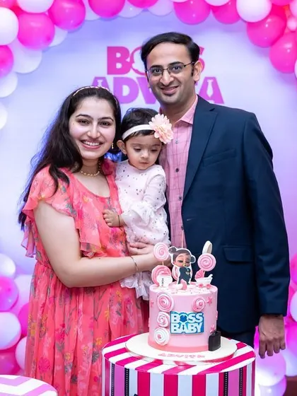 A classic family photo in front of a 'Boss Baby' themed balloon arch. We ensure you get those essential family portraits with the beautiful decor you planned.