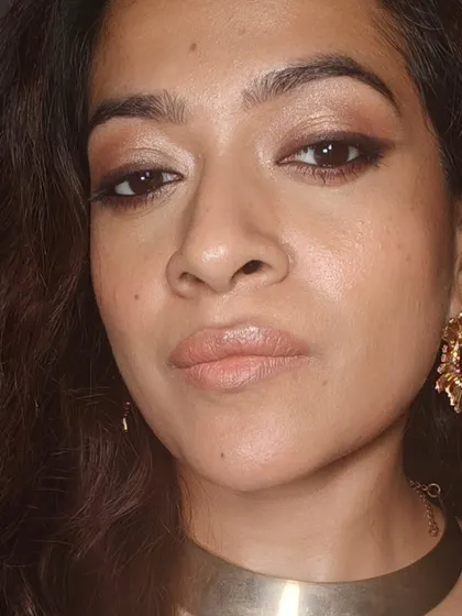 A close-up of the golden eye makeup. The colors are warm and inviting, perfect for the holiday season.