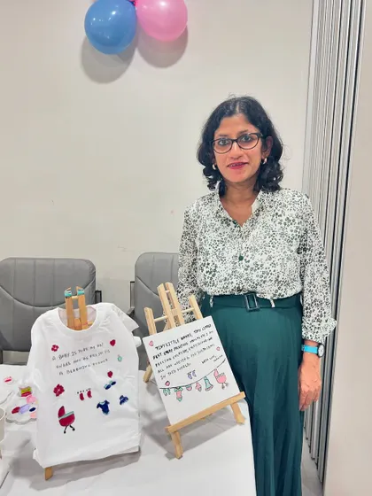 An elegant hand-painted baby t-shirt and canvas, created as a heartfelt gift during a baby shower.