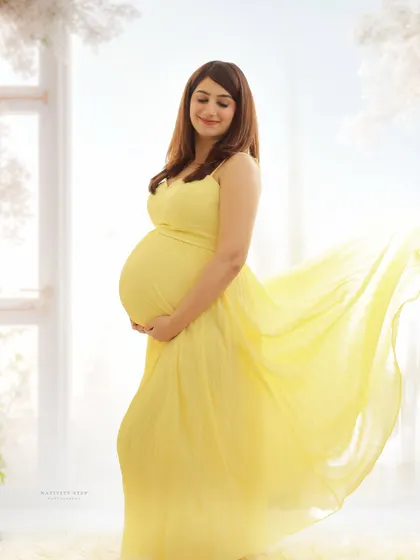 A bright and airy portrait in a flowing yellow gown. The wind effect on the dress and the soft backlighting create a feeling of freedom and joy.