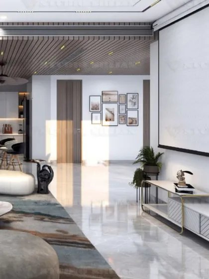 A lounge area in Kirti Nagar featuring a large projector screen for a home-cinema experience. The design is clean and modern, with a focus on comfort.