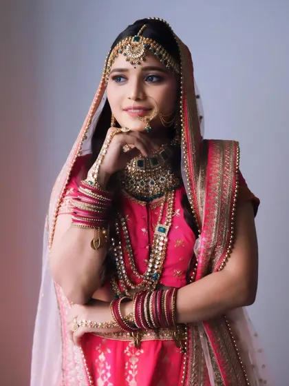 A classic bridal pose that highlights the detailed makeup and jewelry.