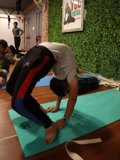 A strong Chakrasana (Wheel Pose) in our studio, with the Yog Yatra logo in the background, reminding us of our shared journey.