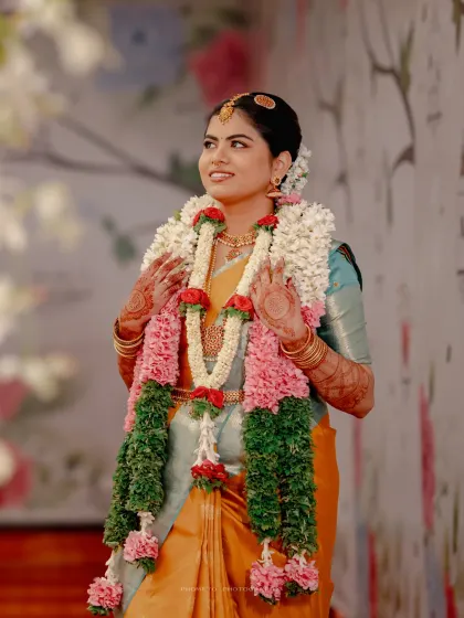 A stunning portrait of an Iyengar bride, adorned with beautiful garlands of flowers.