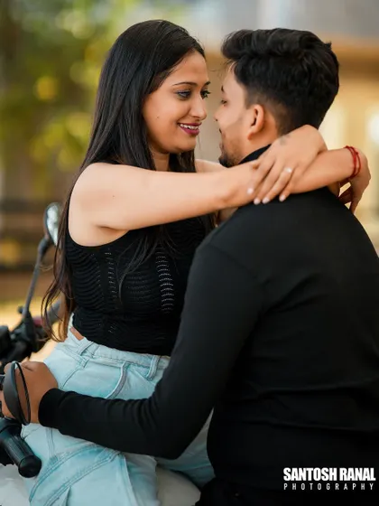 An intimate and loving moment between a couple on a motorcycle.