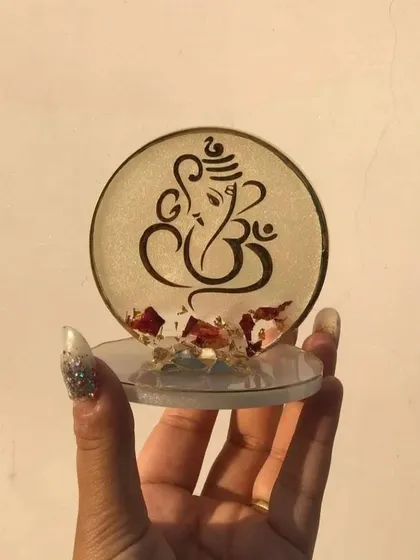 This mini stand features a Ganesha design in a clear resin with red flower petals at the base. It shows how I can create a more subtle and delicate look based on your preference.