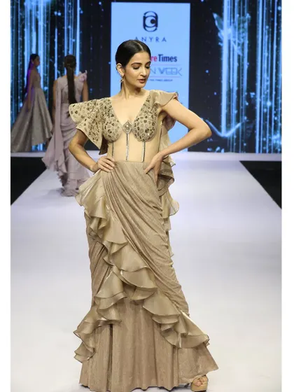 A full view of the beige saree gown, showing how the structured corset and flowing ruffles come together to create a balanced and elegant fusion silhouette.