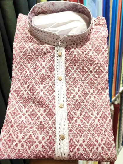A folded view of a men's kurta from my 2023 Diwali collection. This piece features intricate chikankari-style embroidery in a beautiful dusty rose color.