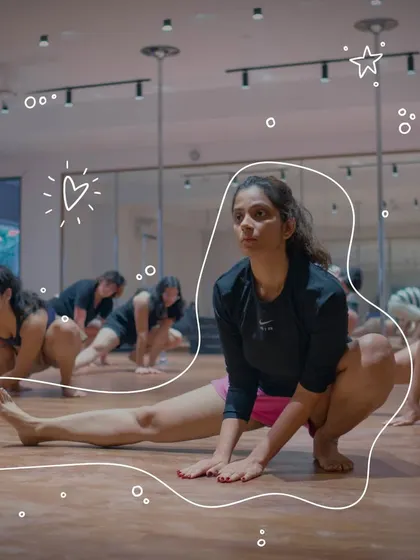 Flexibility is a key component of pole art. This image shows participants in a group stretch, an essential part of our workshop to ensure safe and effective movement.