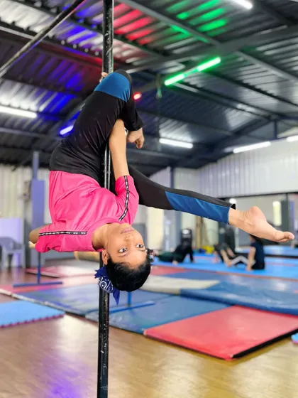 Ready to take flight? This student showcases a powerful and flexible pose on the pole, demonstrating the harmony between body and apparatus that we teach.
