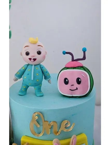A detailed shot of the JJ and Cocomelon TV figurines, which are some of the most requested characters for toddler birthdays.