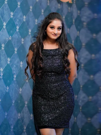 A confident and direct-to-camera portrait. The glamorous eye makeup and soft lip color make a statement, perfect for a portfolio or social media profile.