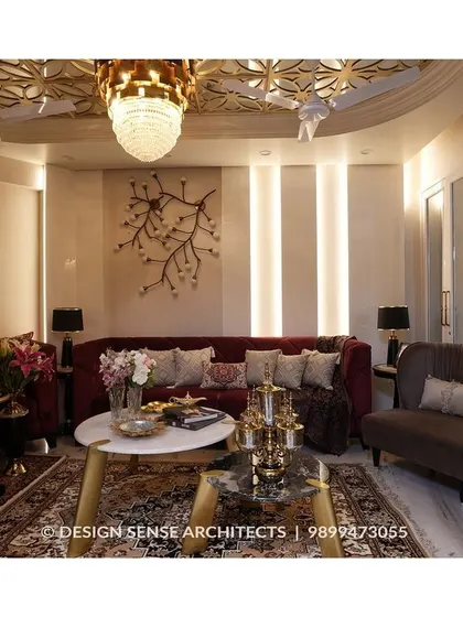 We brought a client's dream of living in a five-star hotel to life with this opulent living room. The design features a detailed false ceiling with a grand chandelier, rich velvet sofas, and custom wall art, all coming together to create an atmosphere of pure luxury and comfort.