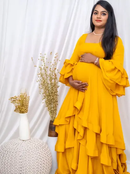 This yellow maternity gown is made from a comfortable, flowing fabric that drapes beautifully over your baby bump.