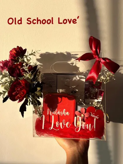 For a touch of "Old School Love", this personalized clear bag hamper is a great choice. It includes a custom mug and a bouquet of red flowers, with a handwritten style message on the bag itself.
