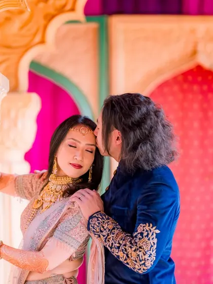 A tender forehead kiss captured in a colorful, traditional setting. This photo, taken for my clients from Japan, shows that love is a universal language.
