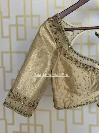The blouse on a hanger, showing the overall design.