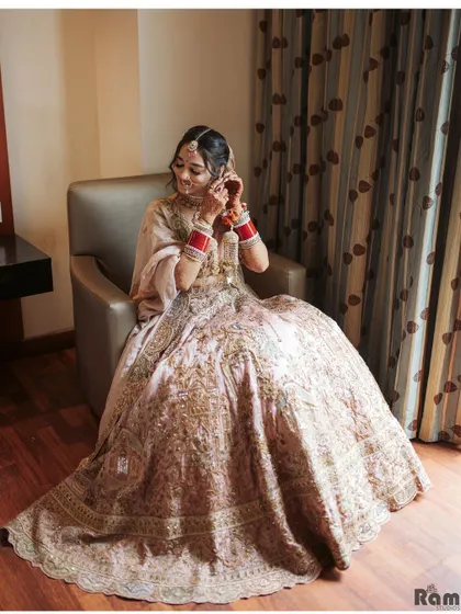 A candid moment of the bride getting ready in her hotel room, adjusting her earring with a smile.