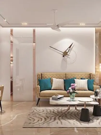 Even compact apartments can feel incredibly luxurious. This living and dining space uses a cohesive palette of beige and gold, with mirrored panels and smart lighting to create a sense of spaciousness and elegance.