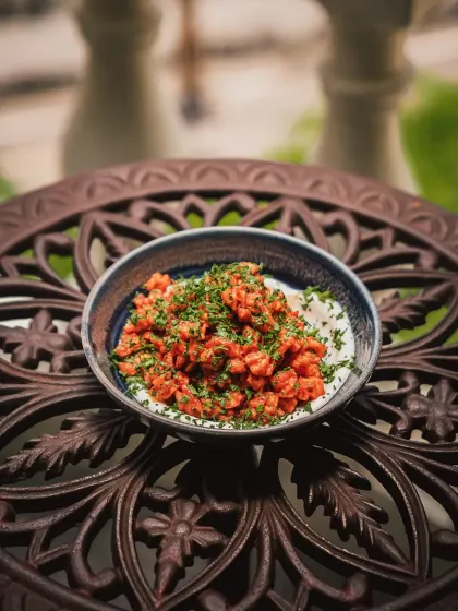 Inspired by Beiruti drama, these golden Batata Harra potatoes are bright with lemon zest, tangled in fresh herbs, and unapologetically bold.