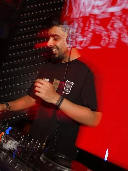 A motion-blurred shot of me enjoying the music at the console. This captures the dynamic and fast-paced nature of a live DJ set.