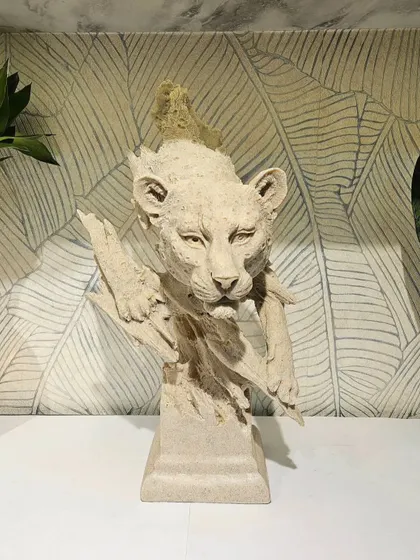 A beautiful lion cub sculpture, also in our signature stone-finished resin. This piece captures a sense of innocence and wild beauty.