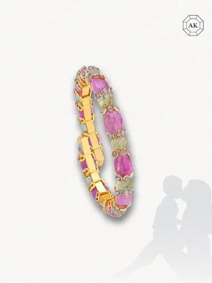 A vibrant and unique spring-style bracelet adorned with exquisite emeralds and sparkling tanzanite round rose cuts in 14k gold. Designed for versatility, it transitions effortlessly between Indian and Western outfits.