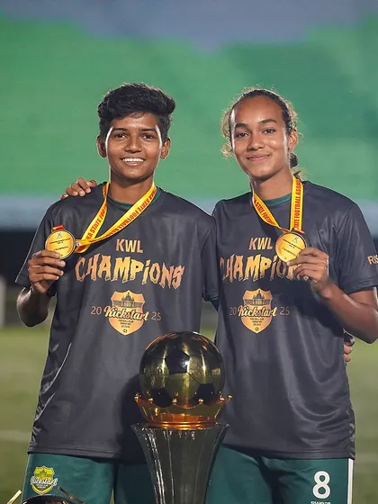 Teammates and champions. Two players proudly display their gold medals after winning the KWL championship, a perfect example of shared success.