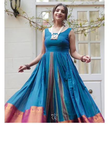 A joyful Yale blue dress with a traditional silk border, perfect for any festive celebration. Its full skirt has a beautiful twirl.