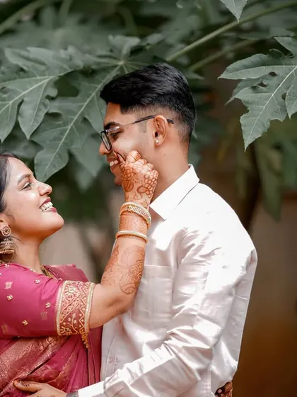 A sweet, candid moment with the bride playfully touching the groom's cheek.