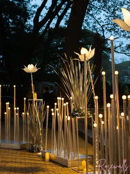 The pathway for this silver jubilee was lit with dozens of glowing orbs and tall, elegant light-up lotus flowers, creating an enchanting and romantic atmosphere for the evening celebration.