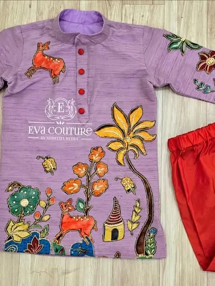 A hand-painted boys' kurta set in lilac and red. The kurta is adorned with colorful paintings of animals and nature, creating a playful and artistic ethnic outfit.