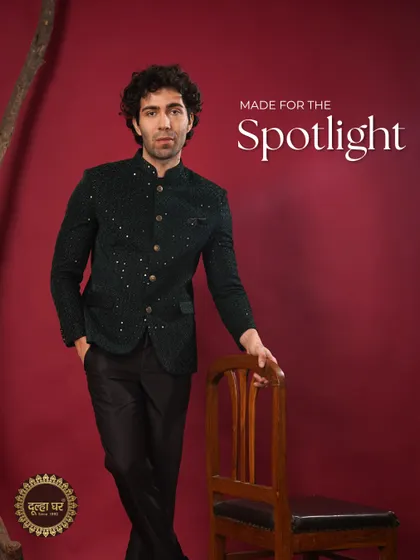 Made for the spotlight. This dark green sequined Bandhgala jacket paired with black trousers is a showstopper, designed for a groom who wants to shine.