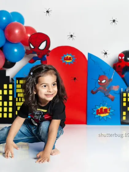 A candid shot of our little Spiderman, looking off to the side with a sweet smile during his superhero session.