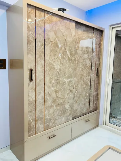 The sliding mechanism is smooth and concealed, maintaining the wardrobe's sleek and modern appearance.