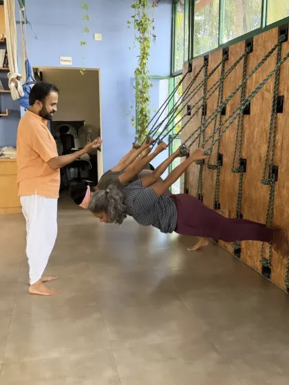 Here, I am guiding students in our Yoga Kurunta workshop, using the rope wall to explore postures with greater support and precision. This unique tool helps decompress the spine, improve alignment, and makes advanced poses more accessible. We integrate props like these to help every student, regardless of their flexibility, experience the deeper benefits of yoga.