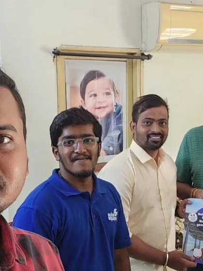 Our team with a customer holding our solar booklet.