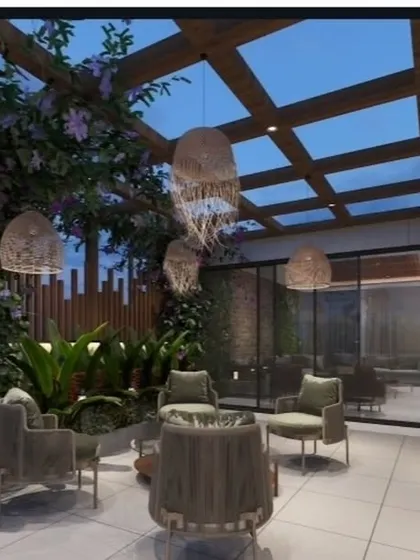 A proposed design for a semi-covered outdoor lounge in Janakpuri. The render highlights a glass and wood pergola, lush tropical plants, and bohemian-style lighting fixtures.