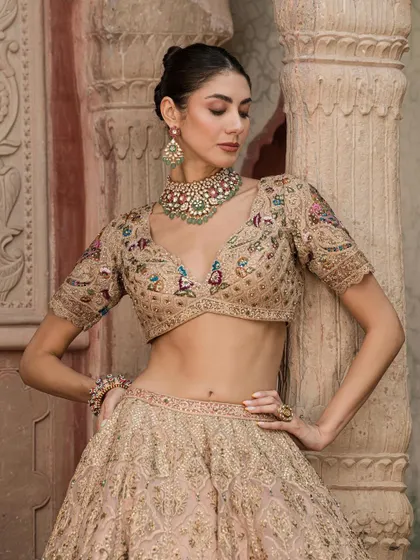 A model looking graceful in a beige lehenga, paired with our unique multi-colored Navratan style choker, blending classic design with contemporary colors.